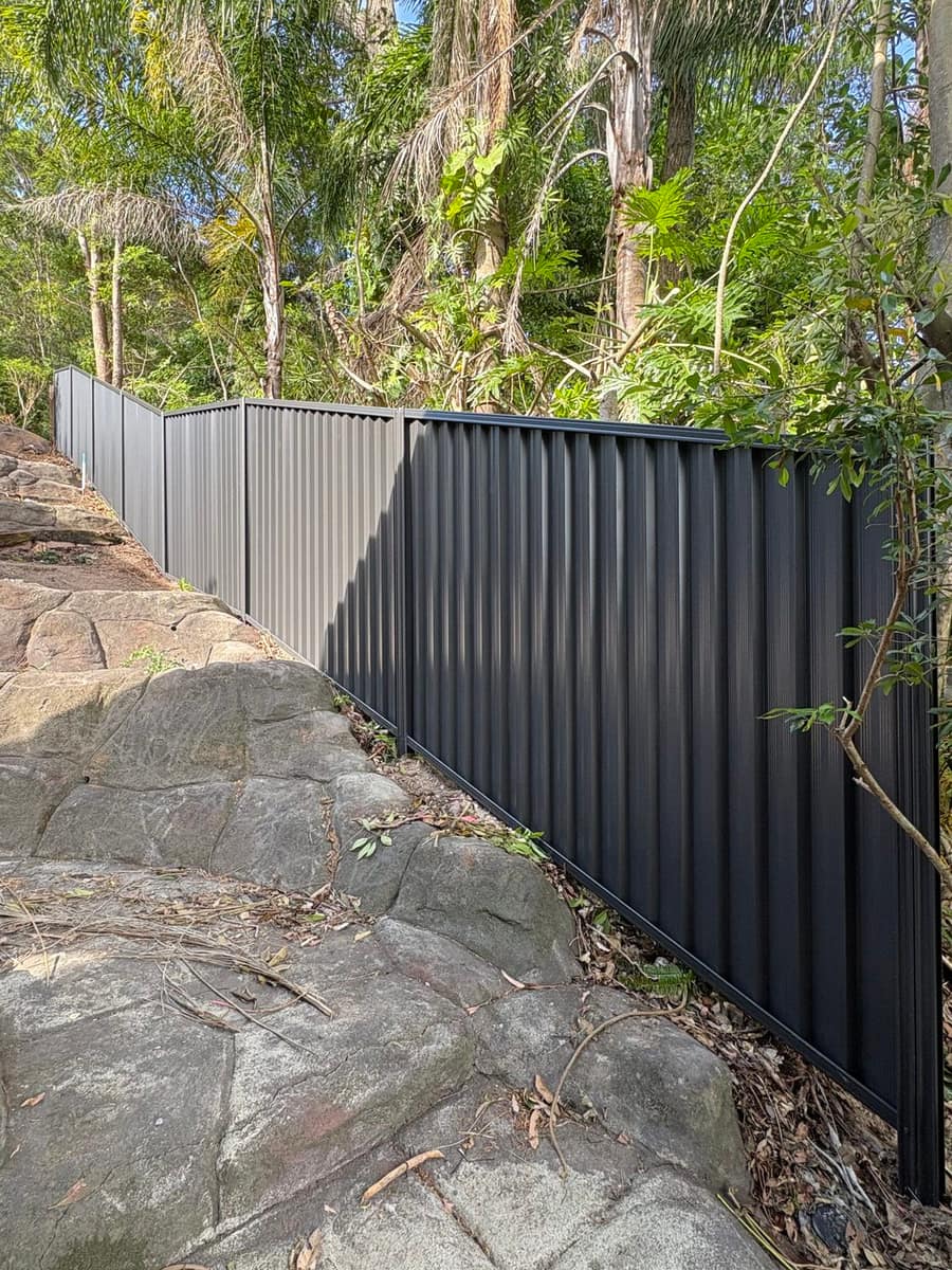 Colorbond fence on a sloped bushland block