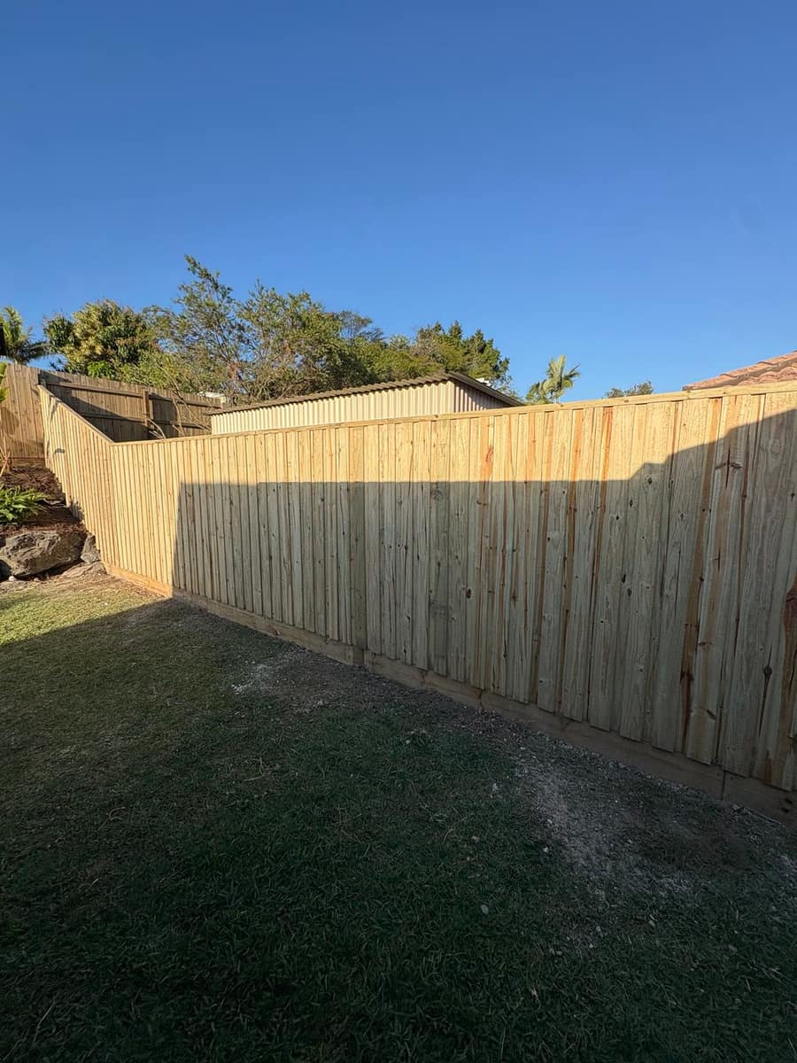 Lapped and capped timber fence with sleepers